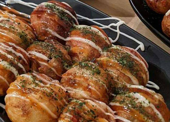 A close-up of homemade takoyaki on a takoyaki food tour.